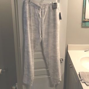 Never worn, light white track pants.